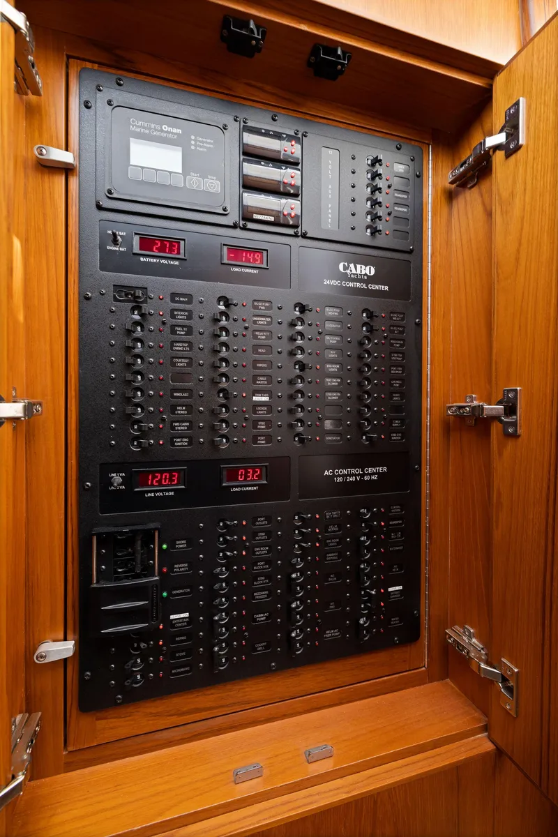Slide: The Image of Electrical control panel inside a 2012 Cabo 44 Hardtop Express boat. - 24