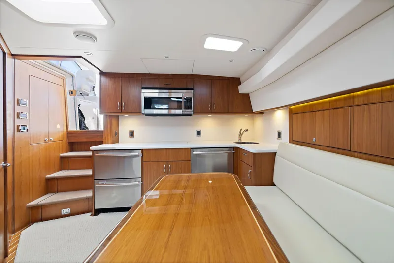 Slide: The Image of Luxurious interior of 2012 Cabo 44 Hardtop Express yacht with modern kitchen and dining area. - 3