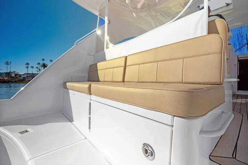 Slide: The Image of 2012 Cabo 44 Hardtop Express boat with beige cushioned seating. - 30