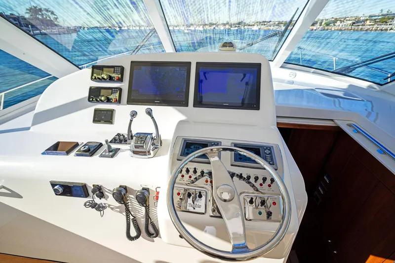 Slide: The Image of Helm of 2012 Cabo 44 Hardtop Express with navigation screens and controls. - 36