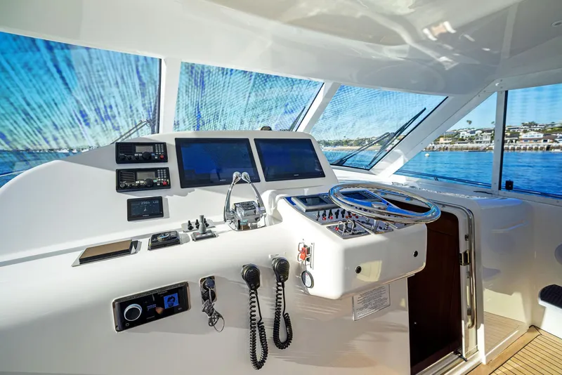 Slide: The Image of 2012 Cabo 44 Hardtop Express yacht helm with advanced navigation systems and ocean view. - 38