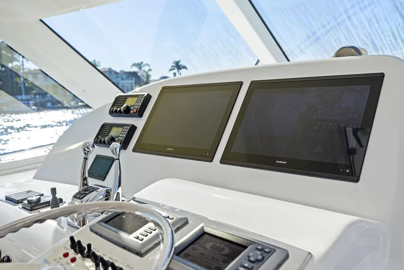 Slide: The Image of Helm station of 2012 Cabo 44 Hardtop Express with dual Garmin displays. - 41