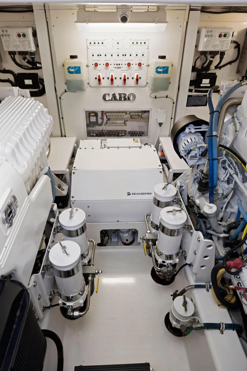 Slide: The Image of Engine room of a 2012 Cabo 44 Hardtop Express yacht with clean, organized components. - 43