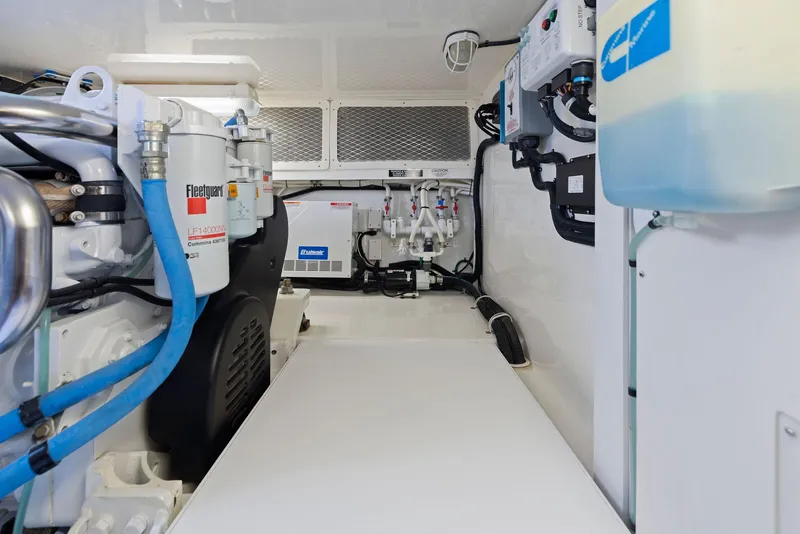 Slide: The Image of Engine room of a 2012 Cabo 44 Hardtop Express yacht with various mechanical components. - 46