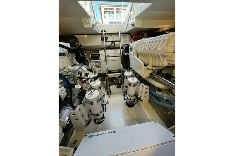 Slide: The Image of Engine room of 2012 Cabo 44 Hardtop Express, showcasing mechanical components and systems. - 74