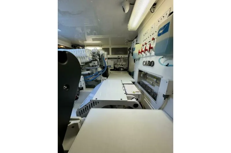Slide: The Image of Engine room of 2012 Cabo 44 Hardtop Express, showcasing mechanical components and control panels. - 75