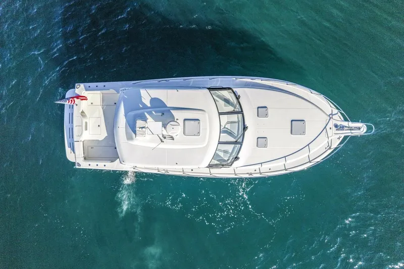 Slide: The Image of Overhead view of 2012 Cabo 44 Hardtop Express yacht on blue ocean water. - 77