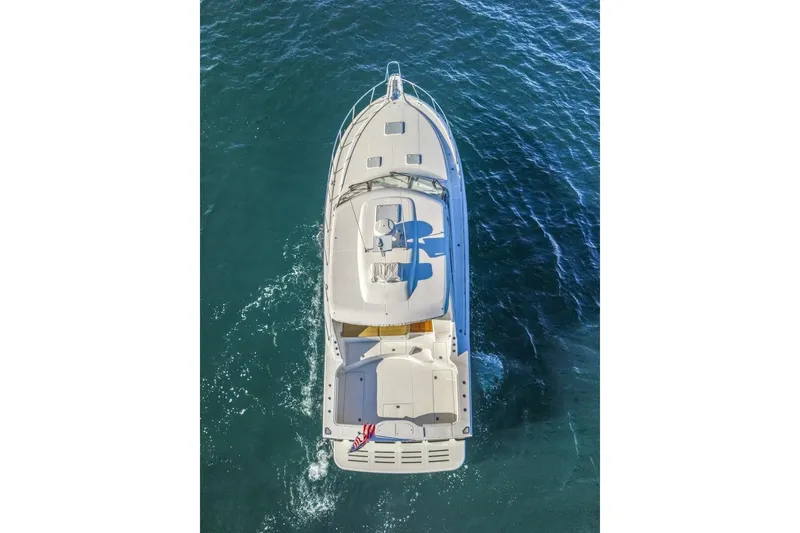 Slide: The Image of Aerial view of 2012 Cabo 44 Hardtop Express yacht cruising on blue ocean waters. - 89