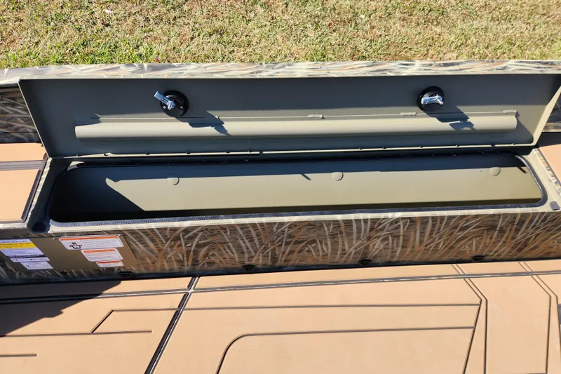 Slide: The Image of Open storage compartment on 2026 Tracker Grizzly 1756 T Marsh boat, camo design. - 10