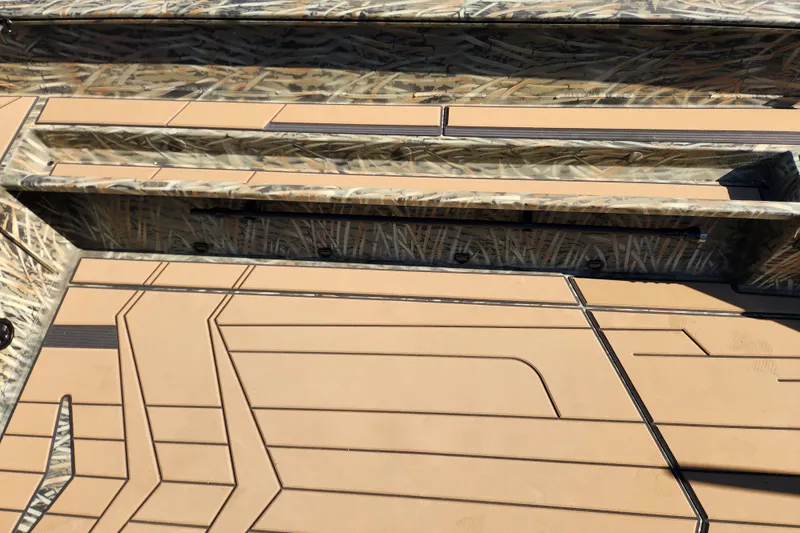 Slide: The Image of 2026 Tracker Grizzly 1756 T Marsh boat interior with camouflage and tan deck design. - 11