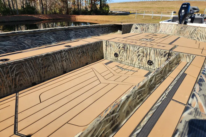 Slide: The Image of 2026 Tracker Grizzly 1756 T Marsh boat with camo design and spacious deck. - 14