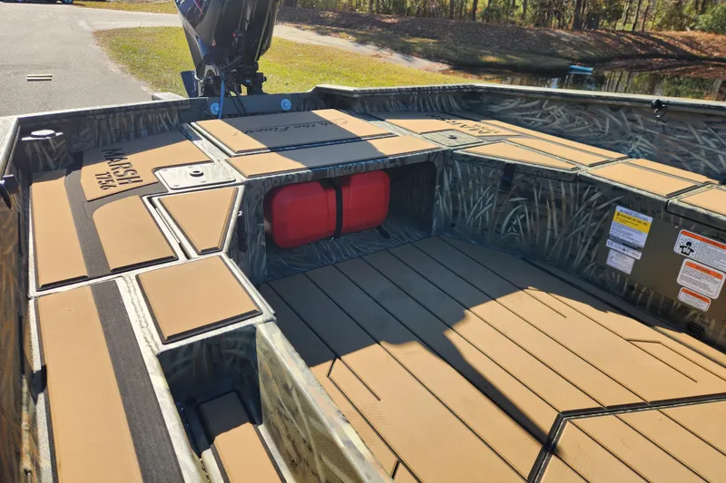 Slide: The Image of 2026 Tracker Grizzly 1756 T Marsh boat interior with camo design and storage compartments. - 15