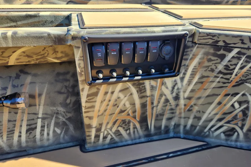 Slide: The Image of Control panel of 2026 Tracker Grizzly 1756 T Marsh boat with camouflage design. - 18