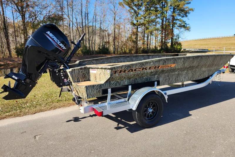 Slide: The Image of 2026 Tracker Grizzly 1756 T Marsh boat on trailer, featuring Mercury outboard motor. - 2