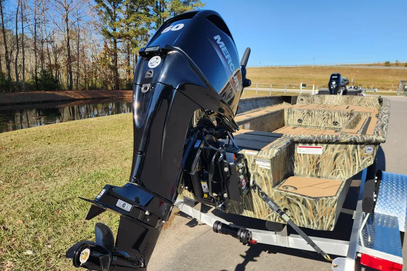 Slide: The Image of 2026 Tracker Grizzly 1756 T Marsh boat with Mercury outboard motor on trailer. - 3