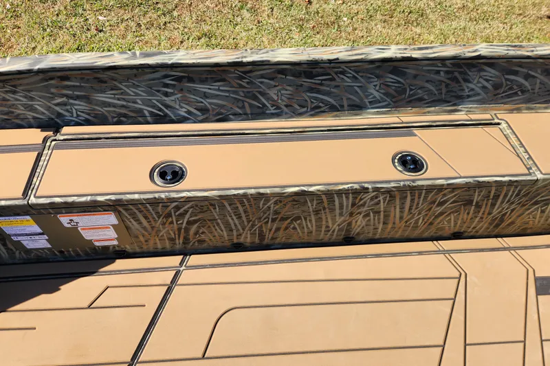 Slide: The Image of 2026 Tracker Grizzly 1756 T Marsh boat interior with camo design and storage compartments. - 9