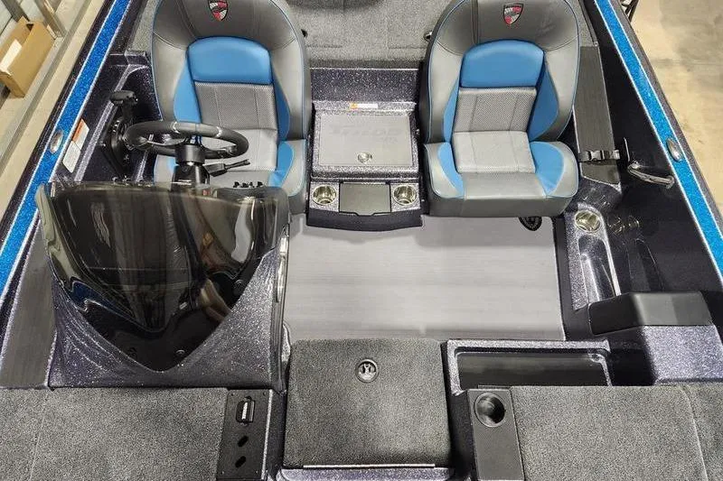 Slide: The Image of 2026 Triton 19 TrX Patriot boat interior with dual seats and steering console. - 10