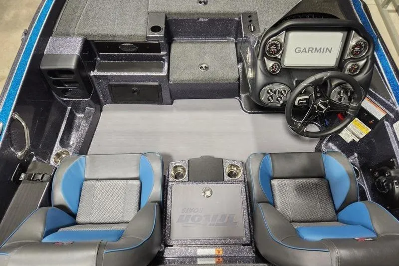 Slide: The Image of 2026 Triton 19 TrX Patriot boat interior with Garmin display and dual blue seats. - 6