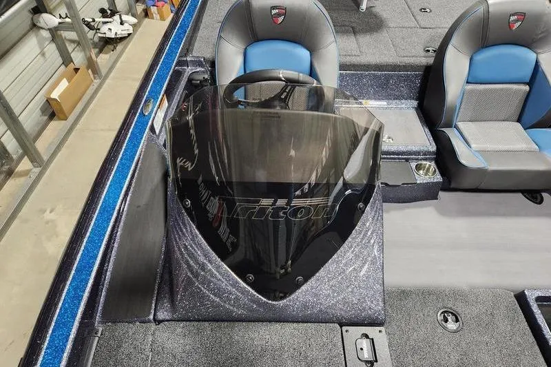 Slide: The Image of 2026 Triton 19 TrX Patriot boat interior with blue and gray seating. - 9