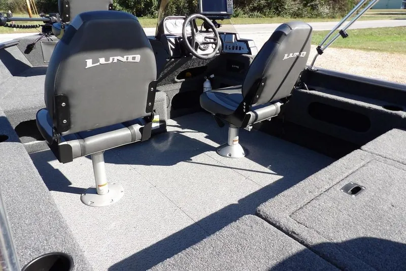 Slide: The Image of 2023 Lund 1675 Adventure SS boat interior with two seats and steering console. - 10