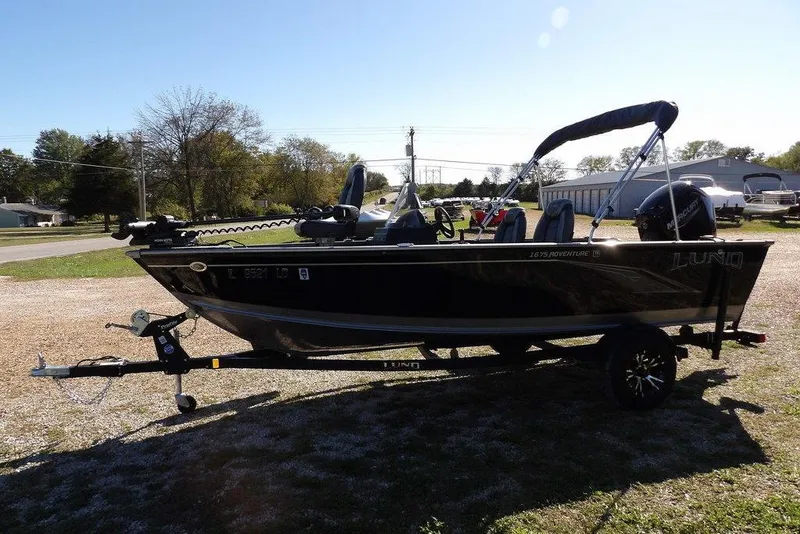Slide: The Image of 2023 Lund 1675 Adventure SS boat on trailer, parked outdoors. - 11