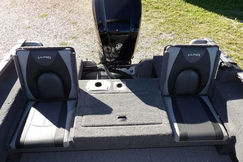 Slide: The Image of 2023 Lund 1675 Adventure SS boat interior with two cushioned seats and motor. - 18