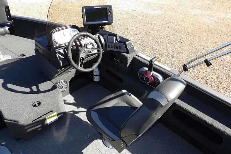 Slide: The Image of 2023 Lund 1675 Adventure SS boat interior with steering wheel and control panel. - 19