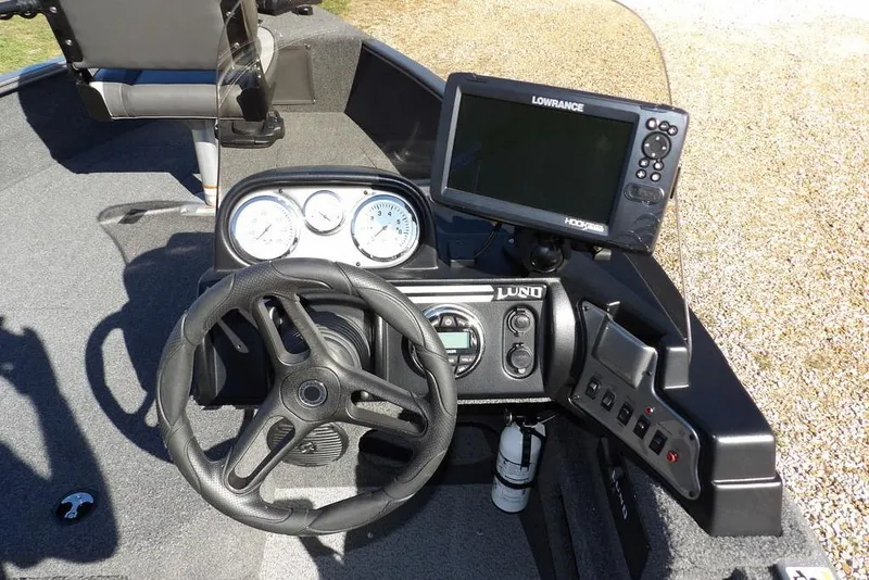 Slide: The Image of 2023 Lund 1675 Adventure SS boat dashboard with steering wheel and Lowrance fishfinder. - 21
