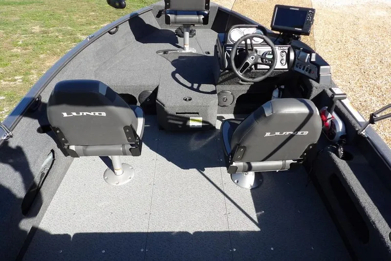 Slide: The Image of 2023 Lund 1675 Adventure SS boat interior with seating and steering console. - 22