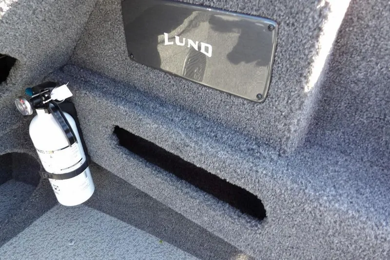 Slide: The Image of Interior of 2023 Lund 1675 Adventure SS boat with fire extinguisher and carpeted finish. - 24
