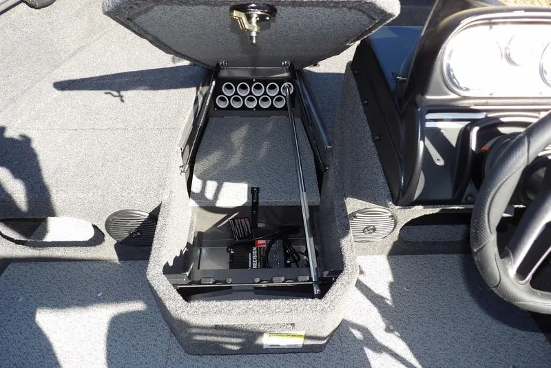 Slide: The Image of 2023 Lund 1675 Adventure SS boat interior storage compartment with rod holders and steering wheel. - 31