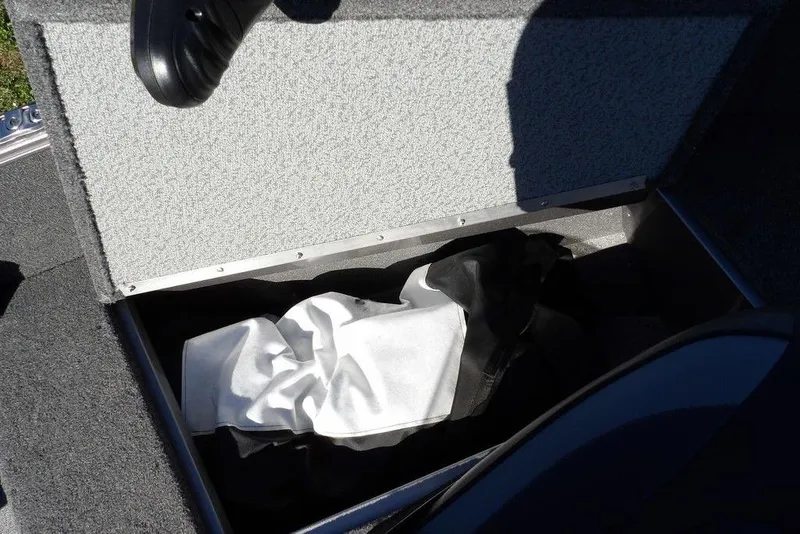 Slide: The Image of Storage compartment in 2023 Lund 1675 Adventure SS boat, containing a folded cover. - 39