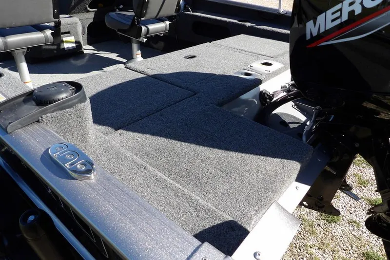 Slide: The Image of 2023 Lund 1675 Adventure SS boat interior with seating and Mercury engine. - 5