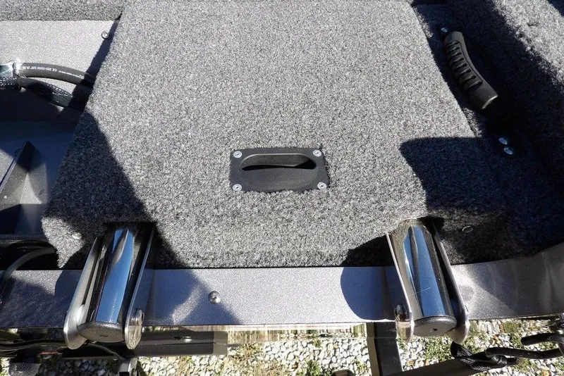 Slide: The Image of 2023 Lund 1675 Adventure SS boat interior with carpeted deck and metal fittings. - 53