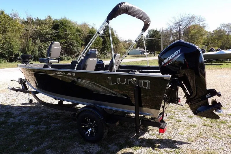 Slide: The Image of 2023 Lund 1675 Adventure SS boat with Mercury outboard motor on a trailer. - 7
