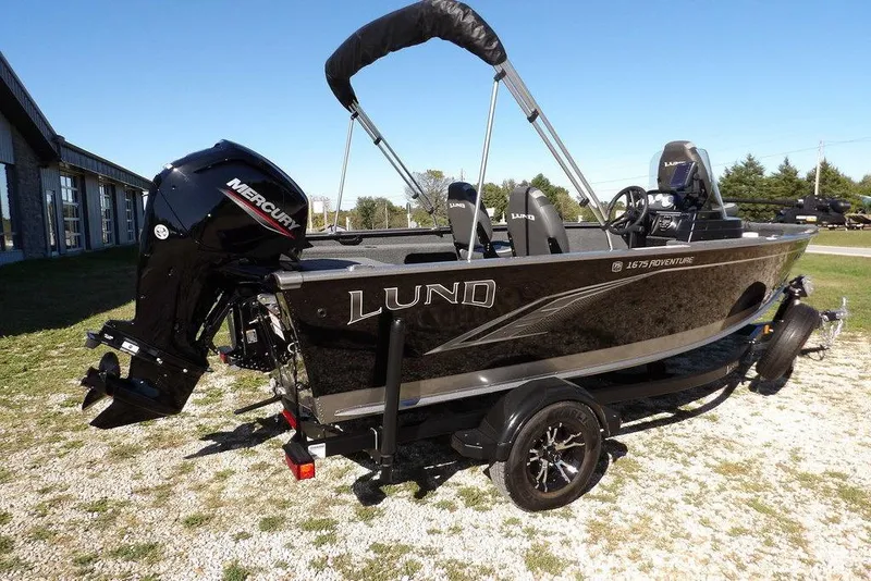 Slide: The Image of 2023 Lund 1675 Adventure SS boat with Mercury engine on trailer, outdoors. - 8