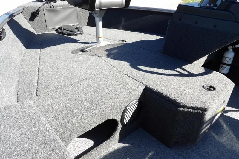 Slide: The Image of 2023 Lund 1675 Adventure SS boat interior with carpeted deck and seating. - 9