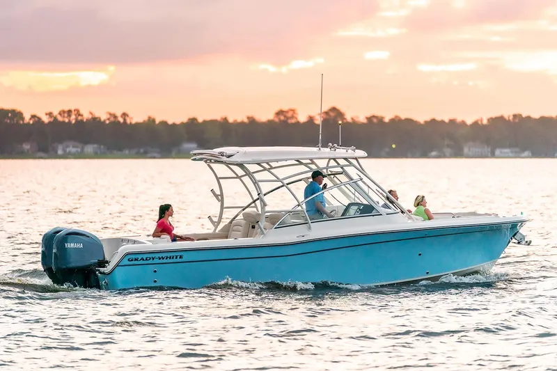 Slide: The Image of Manufacturer Provided Image: 2023 Grady-White Freedom 285 boat cruising on a lake at sunset. - 0