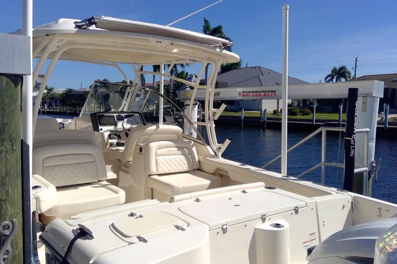 Slide: The Image of 2023 Grady-White Freedom 285 boat docked, featuring spacious seating and modern design. - 12