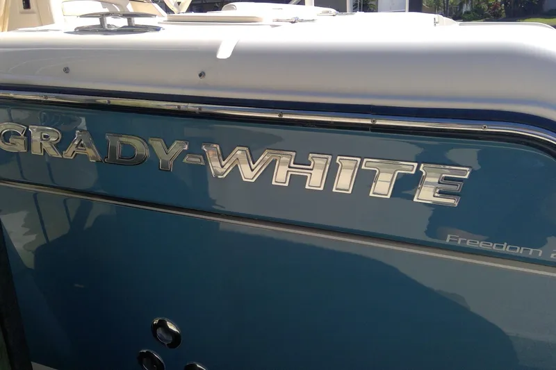 Slide: The Image of 2023 Grady-White Freedom 285 boat, showcasing sleek design and branding. - 14