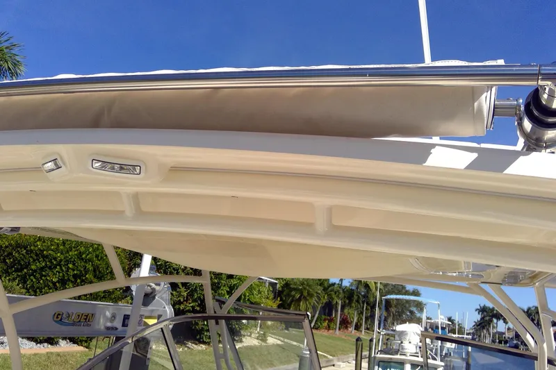 Slide: The Image of 2023 Grady-White Freedom 285 boat canopy and structure, with clear blue sky background. - 20