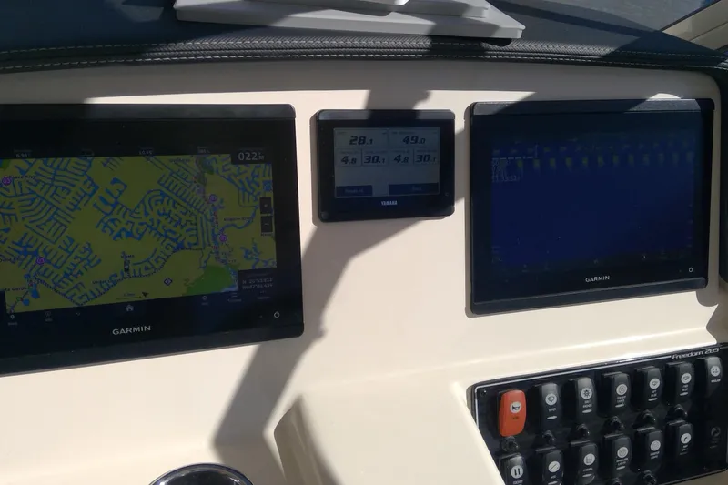 Slide: The Image of Dashboard of 2023 Grady-White Freedom 285 with Garmin navigation displays. - 25