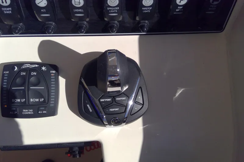 Slide: The Image of Control panel of 2023 Grady-White Freedom 285 boat with joystick and trim tab controls. - 27