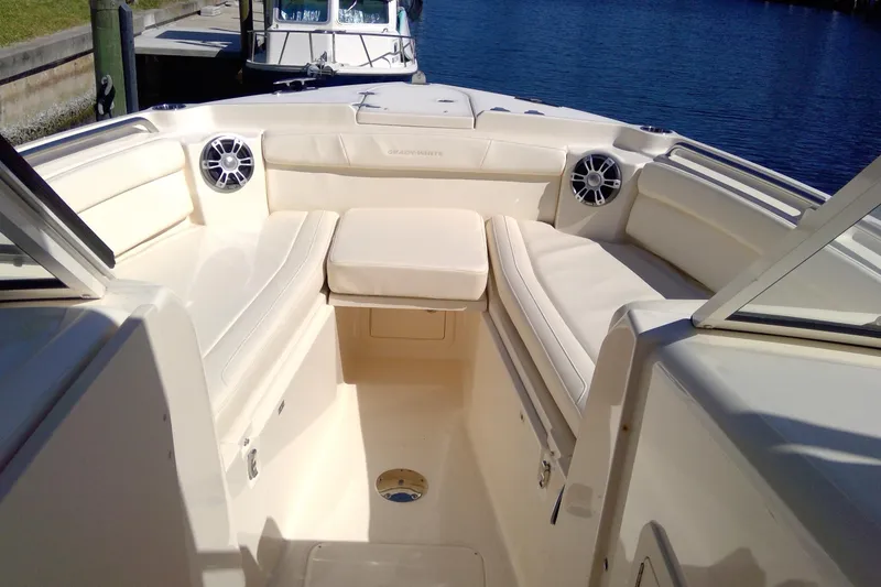 Slide: The Image of 2023 Grady-White Freedom 285 boat interior with cushioned seating and speakers. - 28