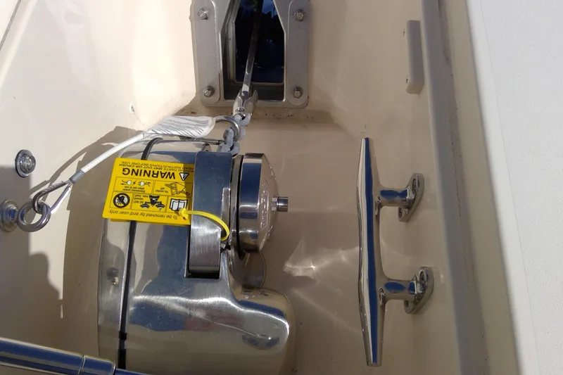 Slide: The Image of 2023 Grady-White Freedom 285 boat anchor winch with warning label and cleat. - 30