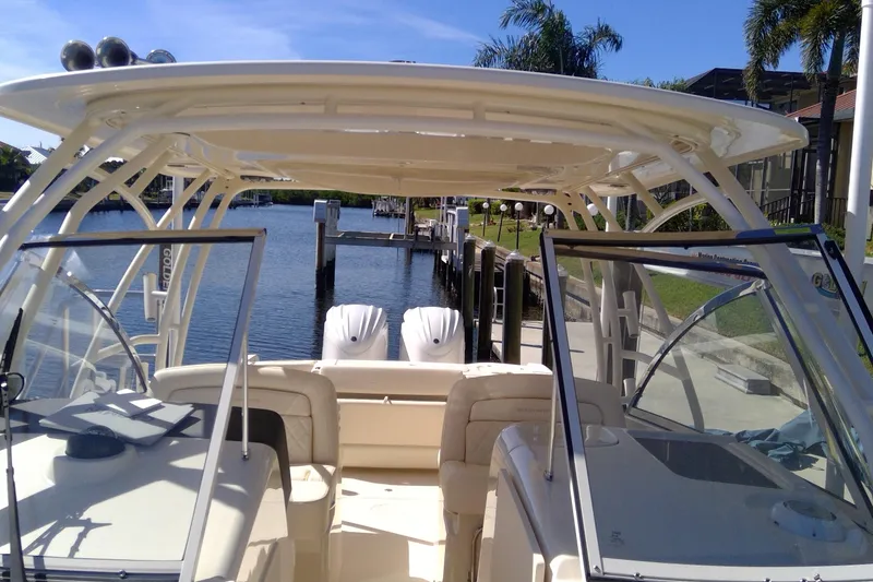 Slide: The Image of 2023 Grady-White Freedom 285 boat docked, featuring dual engines and spacious seating. - 31