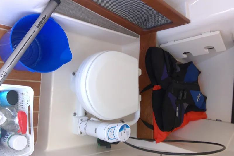 Slide: The Image of Interior of 2023 Grady-White Freedom 285 boat with toilet, life jackets, and cleaning supplies. - 34