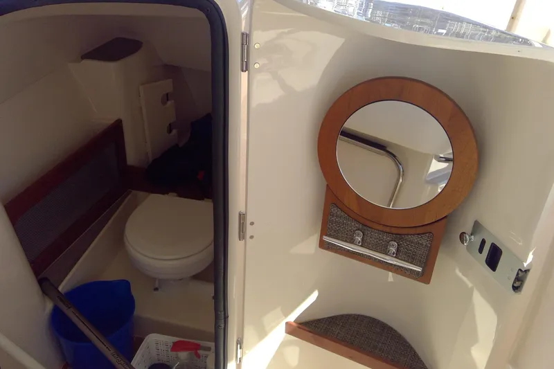 Slide: The Image of 2023 Grady-White Freedom 285 boat interior with toilet and mirror. - 35