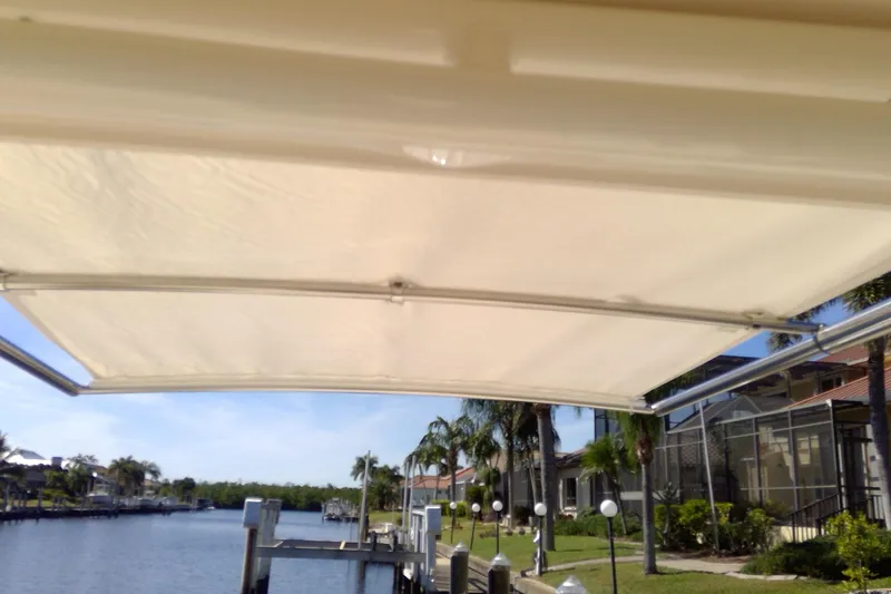 Slide: The Image of 2023 Grady-White Freedom 285 boat canopy with waterfront view and palm trees. - 42