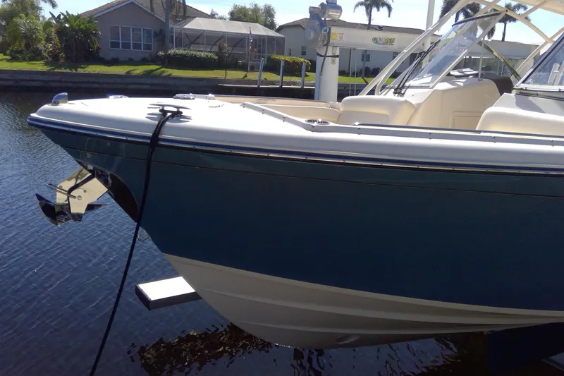 Slide: The Image of 2023 Grady-White Freedom 285 boat docked on calm water, showcasing sleek design. - 45